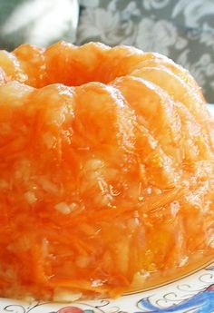 an orange bundt cake sitting on top of a plate