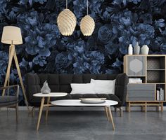 a black and white living room with blue flowers on the wall, two lamps hanging from the ceiling