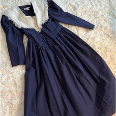 Classically Designed Vintage Dark Navy Dress With Linen Collar & Linen Button Breast Cover. Slightly Puffed Sleeves. Cloth Button Down Front. Flared Skirt. Very Nice Condition. Perfect W My Navy Ferragamo’s:) Navy Vintage Dress, Classic Puff Sleeve Dress With Buttons, Classic Fitted Long Sleeve Prairie Dress, Classic Long Sleeve Dress With Lace Collar, Fitted Long Sleeve Prairie Dress With Buttons, Cotton Victorian Dress For Formal Occasions, Classic Fitted Dress With Smocked Bodice, Formal Cotton Dress With Buttons, Fitted Victorian Dress With Buttons