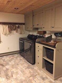 a laundry room with a washer and dryer in the corner next to it