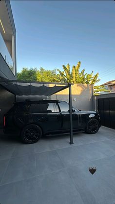 a black car parked in front of a building