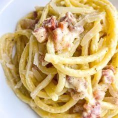 a white plate topped with pasta covered in sauce