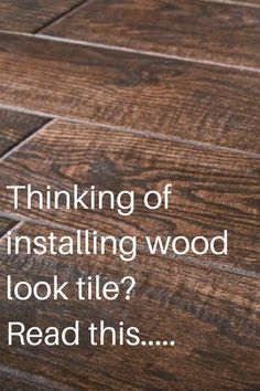 a wooden floor with the words thinking of installing wood look tile read this on it