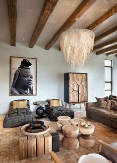 a living room filled with furniture and a chandelier hanging over the top of it