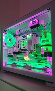 the inside of a computer case with green and pink lights