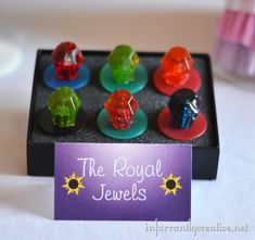 there are some gummy bears sitting on top of a black box that says the royal jewels