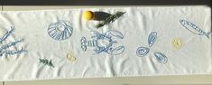 a white towel with blue and yellow designs on it