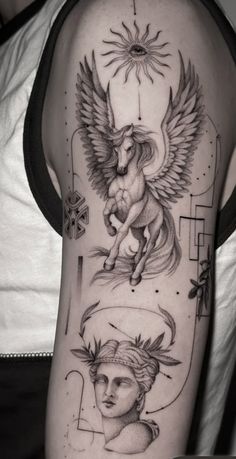 an arm with some tattoos on it and two angels in the middle, one is holding a