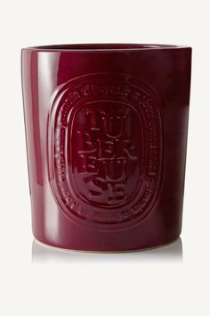 a red glass cup with an emblem on it