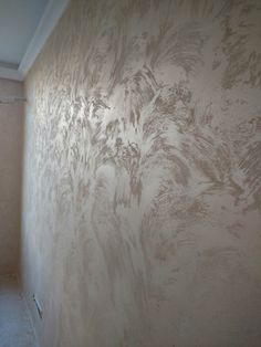 a room with a wall that has some paint on it and a window in the corner