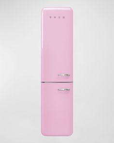 a pink refrigerator freezer sitting on top of a white wall