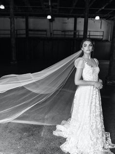 a woman wearing a wedding dress and veil