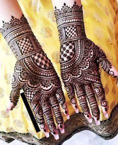 two hands with henna designs on them