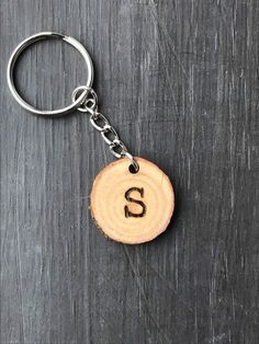 a wooden keychain with the letter s on it