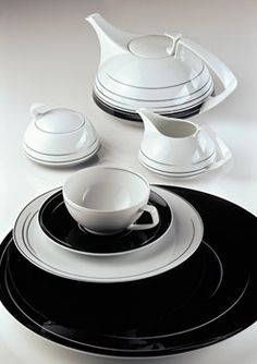 a black and white dinnerware set on a table