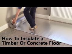 a man is installing a floor in a room with the words how to insulate a timber or concrete floor