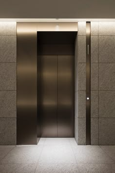 an empty elevator with two doors and no one in the room or on the floor