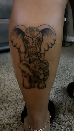 an elephant tattoo on the leg of a woman