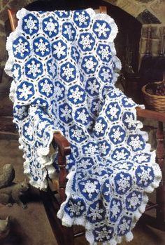 a blue and white crochet doily on a chair