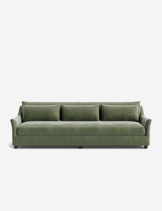 a green couch sitting on top of a white floor