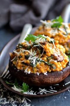 two stuffed mushrooms topped with cheese and parmesan