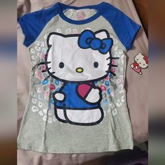 New Hello Kitty Tee Blue Hello Kitty Print Short Sleeve Top, Blue Short Sleeve Top With Hello Kitty Print, Hello Kitty Baby Tee, Blue Cotton Top With Cat Print, Blue Casual Top With Cat Print, Casual Blue Cat Print Top, Casual Blue Tops With Cat Print, Casual Gray Cartoon Print Top, Casual Gray Tops With Cartoon Print