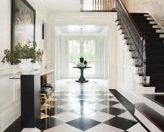 an elegant foyer with black and white checkered flooring