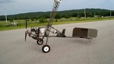 an upside down vehicle sitting on the side of a road