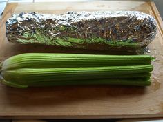 celery stalks wrapped in tin foil on a cutting board