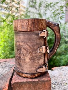 a wooden mug sitting on top of a rock