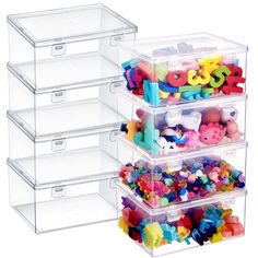 three clear storage containers filled with plastic letters