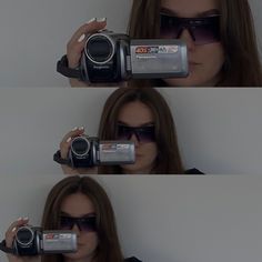 a woman with sunglasses holding up a camera