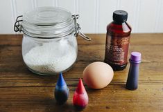 an assortment of items on a wooden table including eggs, salt and pepper shakers