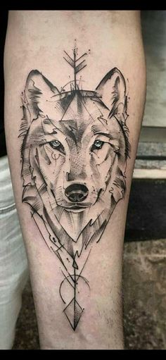 a black and white tattoo on the leg of a man with a wolf head in it