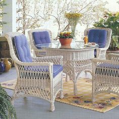 an outdoor patio with wicker furniture and potted plants