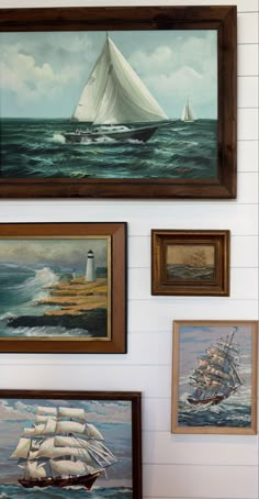 several paintings on the wall with sailboats in them