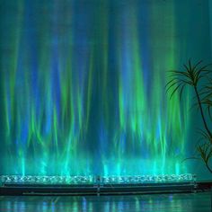 the aurora bore is lit up in green and blue