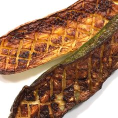 two grilled food items on a white surface