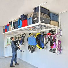 a man standing next to a wall filled with lots of luggage