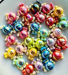 a white plate topped with lots of colorful beads