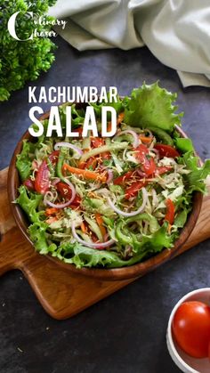 a salad with lettuce, tomatoes and onions in a wooden bowl