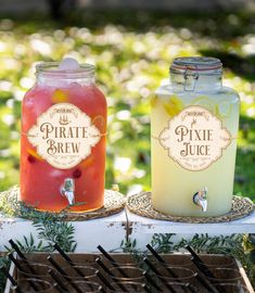 two jars filled with drinks sitting on top of a table