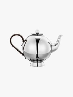 Stainless steel teapot with spherical body and wicker handle.