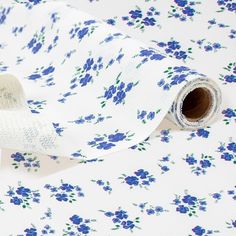 a roll of white and blue floral fabric