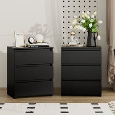 two black dressers with flowers and pictures on them