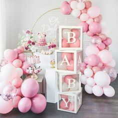 pink and white baby shower decorations with balloons