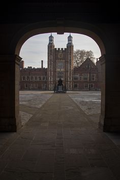 an archway leading to a building with a clock tower