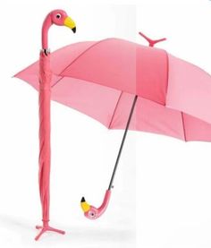 a pink flamingo umbrella with an upside down handle and two small birds on it