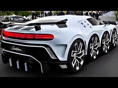 a white sports car parked on top of a parking lot