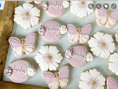 decorated cookies in the shape of flowers and butterflies are displayed on a cookie sheet that says happy birthday